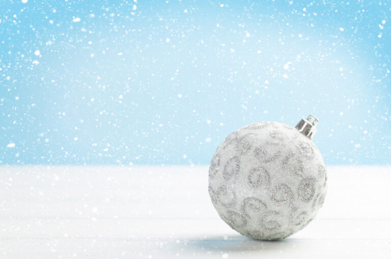 Christmas greeting card with bauble decor over snowy background and copy space for your xmas greetings